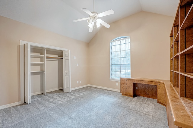 unfurnished bedroom featuring ceiling fan, light colored carpet, and vaulted ceiling