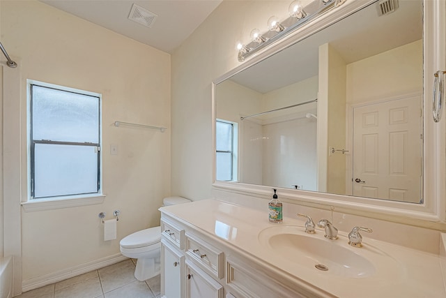 bathroom featuring tile patterned floors, vanity, a healthy amount of sunlight, and toilet