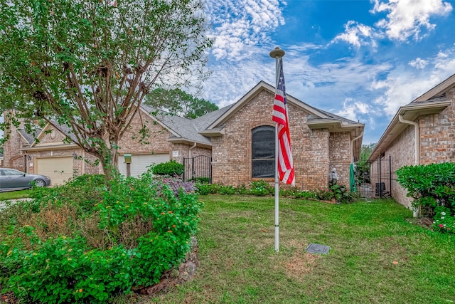 view of front of property featuring a front lawn and a garage