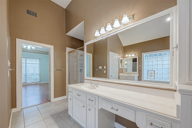 bathroom featuring tile patterned flooring, vanity, an enclosed shower, and lofted ceiling