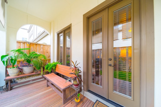 exterior space with covered porch and french doors