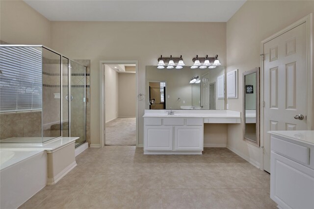 19815 Stanton Lake Dr, Cypress, TX 77433 - bathroom featuring a stall shower, tile patterned flooring, vanity, a garden tub, and baseboards