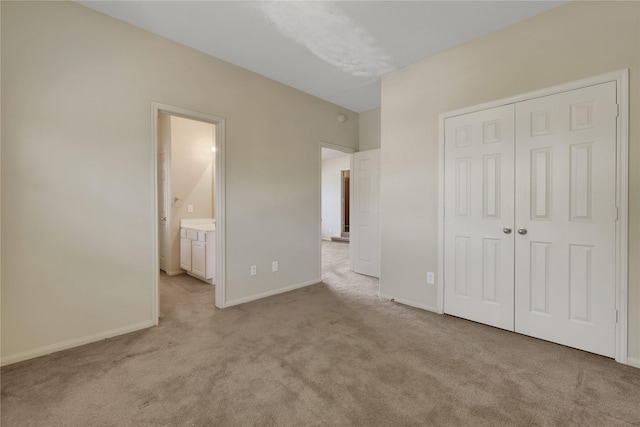 19815 Stanton Lake Dr, Cypress, TX 77433 - unfurnished bedroom with carpet floors, a closet, baseboards, and ensuite bathroom