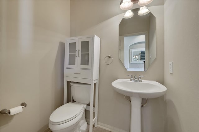 19815 Stanton Lake Dr, Cypress, TX 77433 - bathroom featuring toilet, a sink, and baseboards