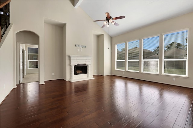 19815 Stanton Lake Dr, Cypress, TX 77433 - unfurnished living room with ceiling fan, high vaulted ceiling, arched walkways, wood finished floors, and a high end fireplace
