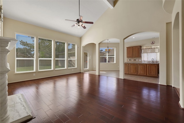 19815 Stanton Lake Dr, Cypress, TX 77433 - unfurnished living room featuring ceiling fan, a sink, light wood-style floors, a chandelier, and high vaulted ceiling
