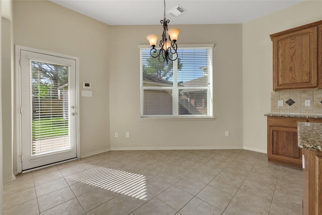 19815 Stanton Lake Dr, Cypress, TX 77433 - unfurnished dining area featuring a chandelier, light tile patterned floors, and baseboards