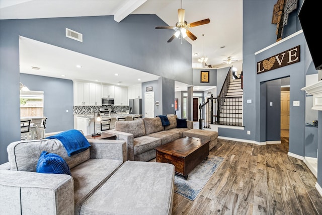 living room with hardwood / wood-style flooring, ceiling fan, high vaulted ceiling, and beamed ceiling