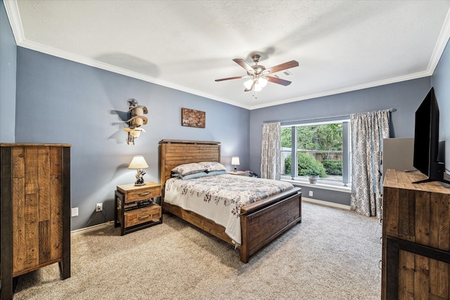 carpeted bedroom with ceiling fan and ornamental molding