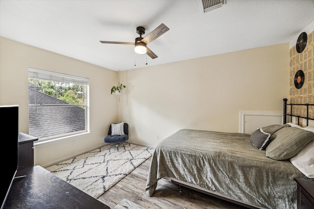 bedroom with ceiling fan and hardwood / wood-style flooring