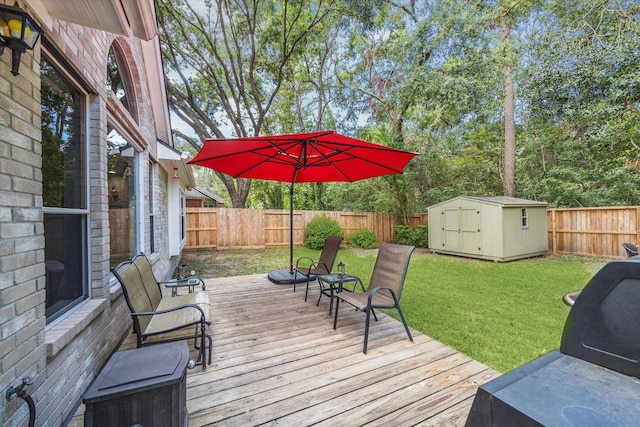 wooden terrace with a lawn and a storage unit