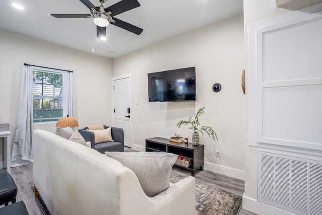 living room with ceiling fan and light wood-type flooring