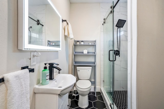 bathroom featuring vanity, toilet, tile patterned floors, and a shower with door