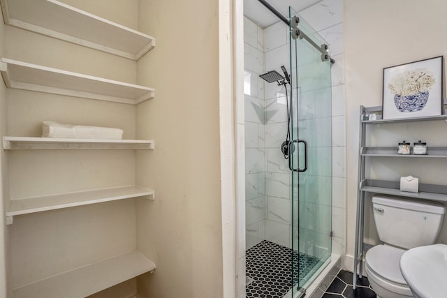 bathroom with toilet, a shower with shower door, and tile patterned floors