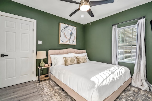 bedroom with ceiling fan and wood-type flooring