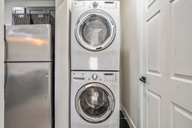 clothes washing area featuring stacked washer / drying machine