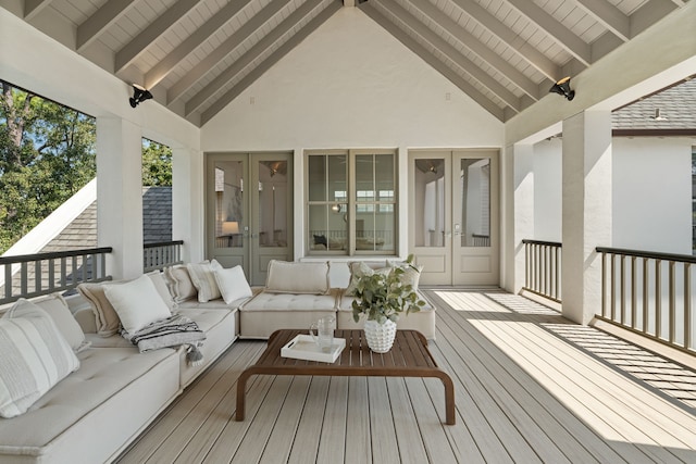 wooden deck with an outdoor living space and french doors