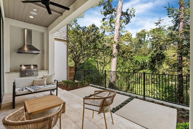 view of patio / terrace featuring grilling area, ceiling fan, and exterior kitchen