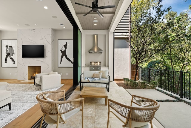 view of patio / terrace featuring an outdoor living space with a fireplace, grilling area, area for grilling, and ceiling fan