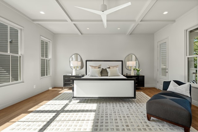 bedroom featuring ceiling fan, light hardwood / wood-style floors, beam ceiling, and coffered ceiling