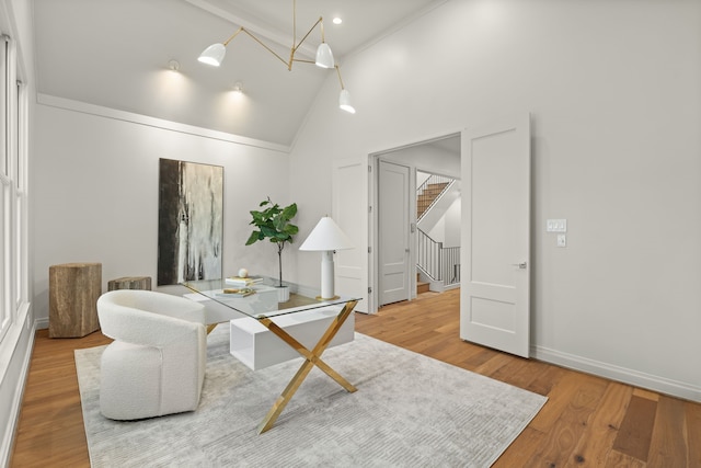 home office featuring hardwood / wood-style floors and high vaulted ceiling