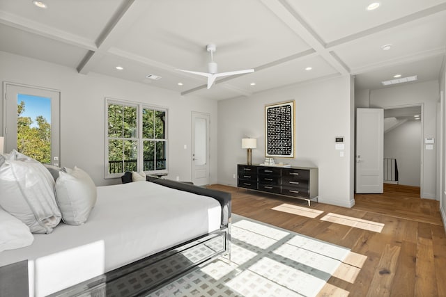 bedroom with hardwood / wood-style floors, ceiling fan, and coffered ceiling