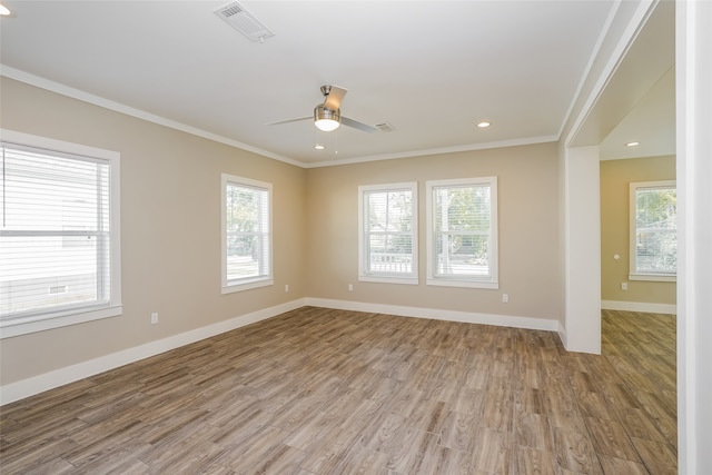 unfurnished room with a wealth of natural light, ceiling fan, crown molding, and light hardwood / wood-style floors