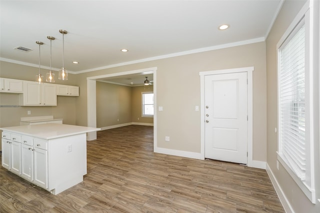 6609 Greenhurst St, Houston, TX 77091 - kitchen featuring crown molding, a ceiling fan, white cabinetry, baseboards, and wood finished floors