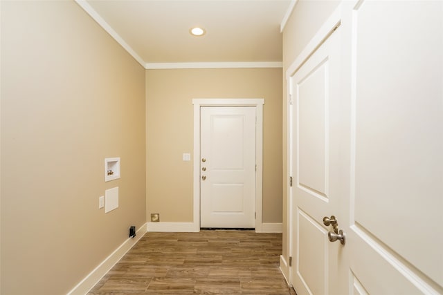 laundry room with hookup for a washing machine, ornamental molding, and light wood-type flooring