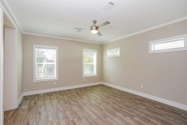 empty room with light wood-type flooring, ceiling fan, and ornamental molding