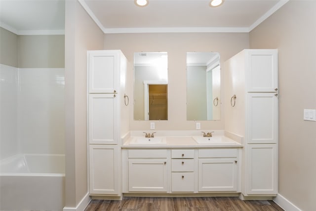 bathroom with crown molding, hardwood / wood-style floors, and vanity