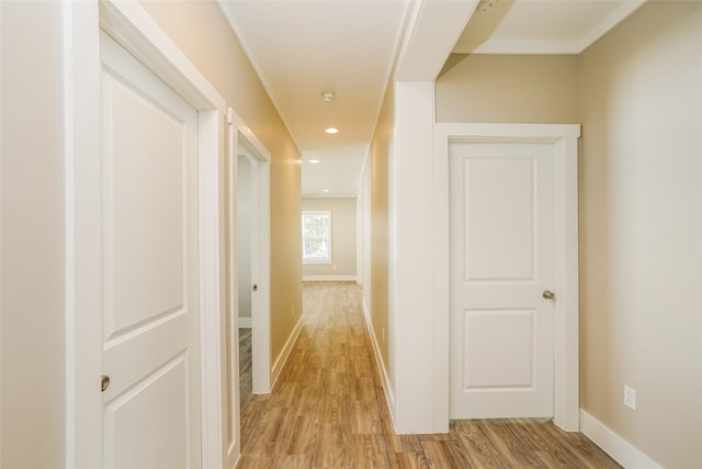 hallway with light hardwood / wood-style floors