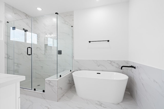 bathroom with shower with separate bathtub and tile walls