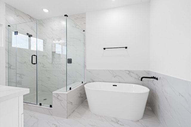 4124 Bucks St, Houston, TX 77020 - full bathroom featuring marble finish flooring, a marble finish shower, a soaking tub, recessed lighting, and a wainscoted wall