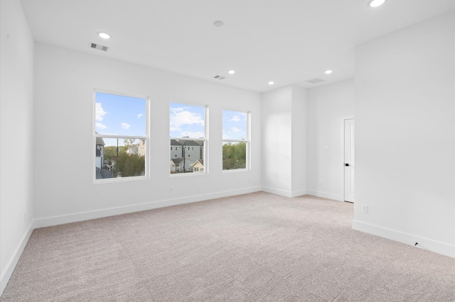 empty room with light colored carpet