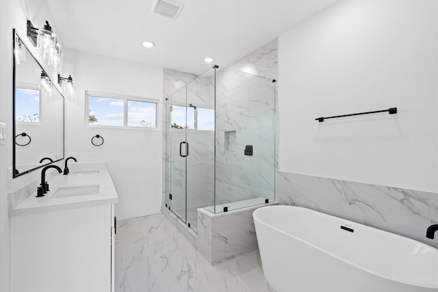 4124 Bucks St, Houston, TX 77020 - full bathroom featuring marble tiled floors, a freestanding bath, a marble finish shower, double vanity, and recessed lighting