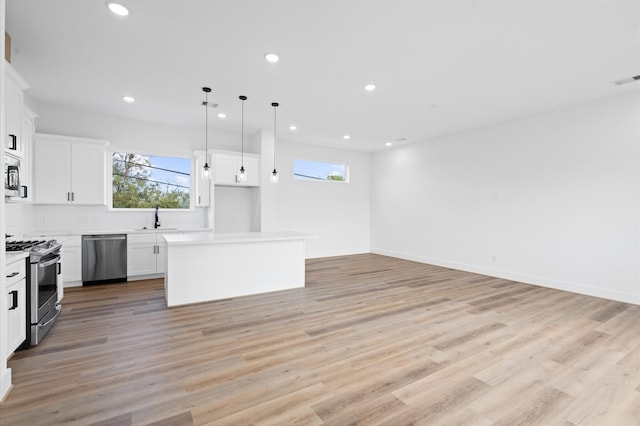 4124 Bucks St, Houston, TX 77020 - kitchen with appliances with stainless steel finishes, a kitchen island, plenty of natural light, recessed lighting, and open floor plan
