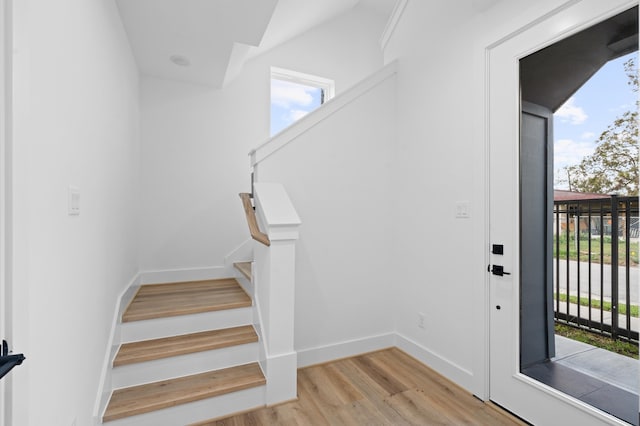 staircase with hardwood / wood-style flooring