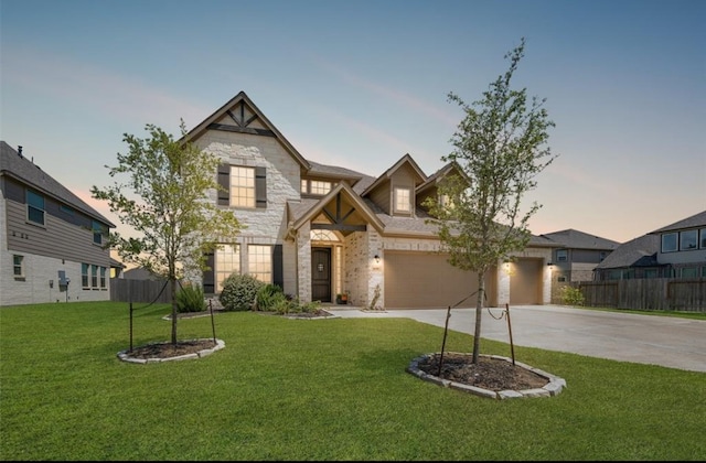 craftsman house with a lawn and a garage