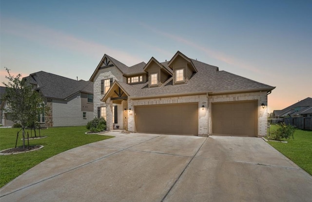 view of front facade with a yard and a garage