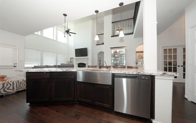 kitchen with pendant lighting, dishwasher, a high ceiling, ceiling fan with notable chandelier, and dark hardwood / wood-style flooring