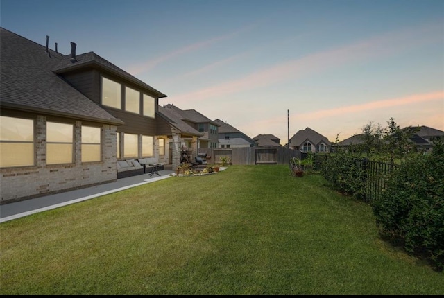 yard at dusk featuring an outdoor hangout area and a patio area