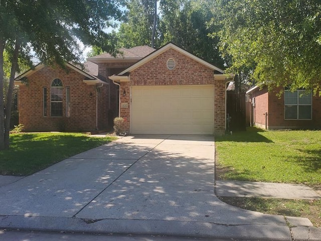 view of front of home with a front yard and a garage