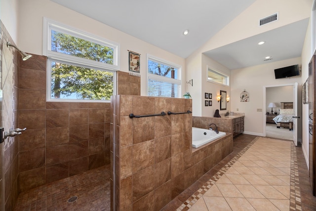 bathroom featuring plus walk in shower, tile patterned floors, lofted ceiling, and sink