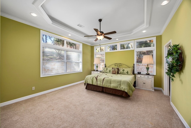 carpeted bedroom with a raised ceiling, ceiling fan, and ornamental molding