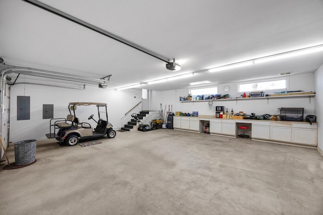 garage with electric panel and a garage door opener