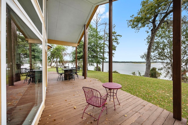 deck with a yard and a water view