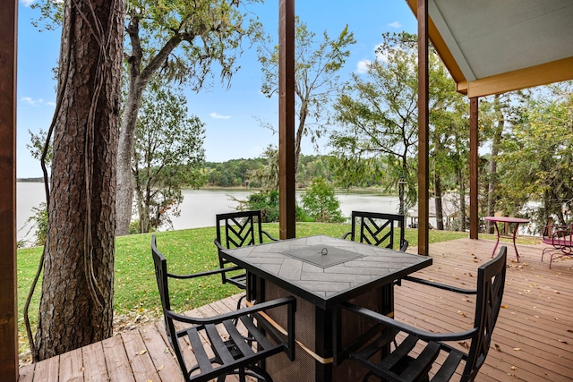 deck featuring a water view and a lawn