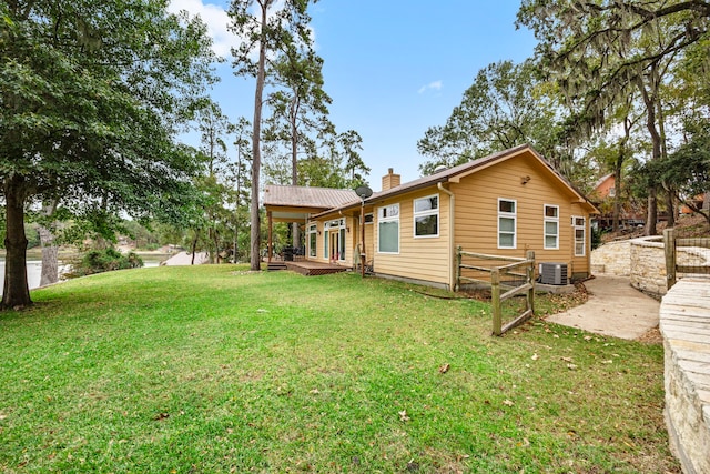 back of house with a lawn and cooling unit