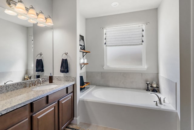 bathroom featuring vanity and a tub to relax in